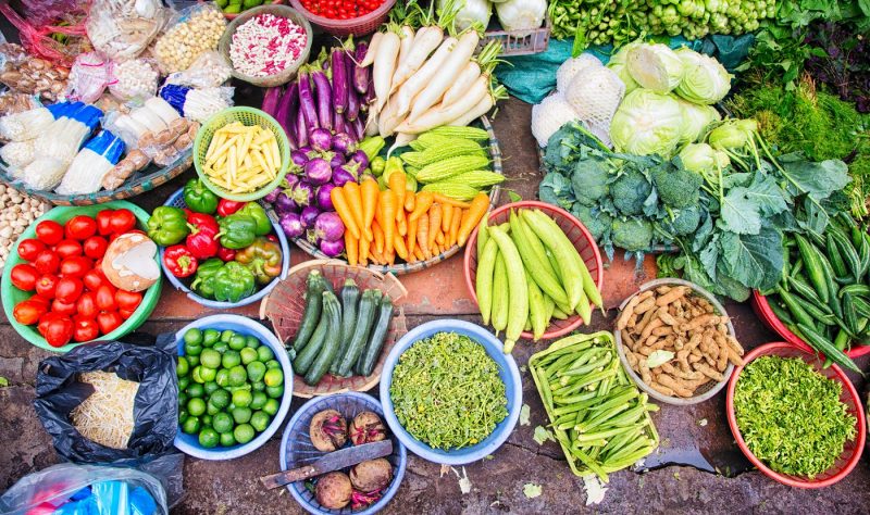 Fresh Vietnamese vegetables fruits spices displayed at Hanoi street market